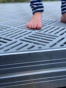 A small foot on SunWalk 45-Series grated decking.